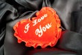 Valentine fluffy heart pillow over black satin Royalty Free Stock Photo