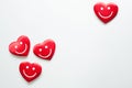 Valentine. Four red hearts with smile emoticons on white background