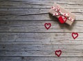 Valentine gift box and heart shape tag on wooden board Royalty Free Stock Photo