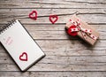 Valentine gift box, notebook and heart shape tag on wooden b Royalty Free Stock Photo