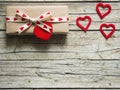 Valentine gift box and red heart on wooden board Royalty Free Stock Photo