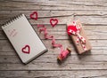 Valentine gift box, ribbon, notebook and heart shape tag on Royalty Free Stock Photo