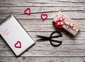 Valentine gift box, scissor, notebook and heart shape tag on Royalty Free Stock Photo