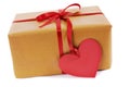 Valentine gift, brown paper parcel, red heart shape gift tag isolated on white Royalty Free Stock Photo