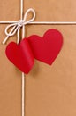 Valentine gift, red heart shape gift tag, brown paper packag Royalty Free Stock Photo