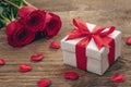 Valentine greeting card background with gift box and fresh burgundy roses Royalty Free Stock Photo