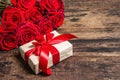 Valentine greeting card background with a gift box and fresh burgundy roses Royalty Free Stock Photo
