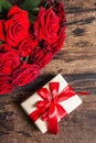 Valentine greeting card background with a gift box and fresh burgundy roses Royalty Free Stock Photo