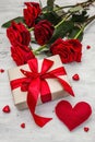 Valentine greeting card background with gift boxes, fresh burgundy roses and assorted hearts Royalty Free Stock Photo