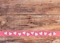 Valentine hearts decoration on red ribbon border and rustic wood background Royalty Free Stock Photo