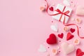 Valentine or mother day composition with gift or present box, rose flowers and red pink hearts on pastel background top view Royalty Free Stock Photo