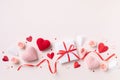 Valentine or mother day composition with gift or present box, rose flowers and red pink hearts on pastel background top view Royalty Free Stock Photo