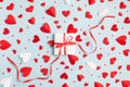 Valentine or Mother day gift or present box with long decorative ribbon and many red hearts on pastel blue background Royalty Free Stock Photo