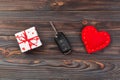 Valentine or other holiday handmade present in paper with red hearts, car keys and gifts box in holiday wrapper. box gift on Dark Royalty Free Stock Photo