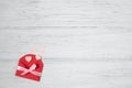 Valentine red envelope with pink hearts. Valentines day card, love flat lay on white wooden background with copy space Royalty Free Stock Photo