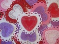 Valentine red, pink, purple, and white lace and doily hearts, horizontal