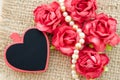 Valentine roses, blank red heart gift tag. Royalty Free Stock Photo