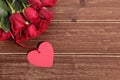 Valentine roses with gift tag on wooden background Royalty Free Stock Photo