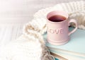 Valentine`s background. Coffee tea mug books knits on wood.