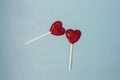 Valentine's card. Two lollipops candy as heart on blue background. Royalty Free Stock Photo