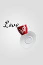 valentine`s cup of coffee with heart balancing in the air or falling on white background, levitation creative design