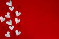 Valentine`s day background concept with space for text. white and red hearts on red background, flat lay Royalty Free Stock Photo