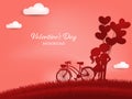 Valentine`s Day background of cute couple with heart shape balloons and bicycle on grass hill with sky and cloud background. Royalty Free Stock Photo