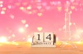 Valentine`s day background. Eiffel tower and vintage wooden calendar with 14th february date