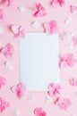 Valentine's Day background. Frame made of pink hydrangea flowers and empty card on pastel pink background.