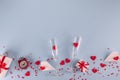 Valentine`s Day background. Gift box , alarm clock , red candy  hearts and paper plane, two champagne glasses on blue background Royalty Free Stock Photo