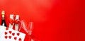 Valentine`s Day background. Gift box, red hearts, bottle champagne in white paper bag and two glasses on red background. Concept: