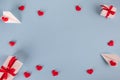 Valentine`s Day background. Gifts, confetti, paper plane on pastel blue background. Valentines day concept.