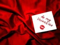 Valentine`s day background with love card on luxury red satin Royalty Free Stock Photo