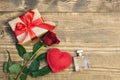 Valentine`s day background with love gift, red roses, perfume and heart shapes. View from above. Copy space. Flat lay. Royalty Free Stock Photo