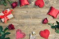 Valentine`s day background with love gift, red roses, perfume and heart shapes. View from above. Copy space. Royalty Free Stock Photo