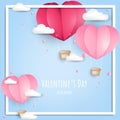 Valentine`s Day background of paper cut heart shape hot air balloon and little pink heart on the blue sky with cloud. Royalty Free Stock Photo