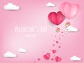 Valentine`s Day background of paper cut heart shape hot air balloon and tiny pink heart falling from hot air balloon. Royalty Free Stock Photo