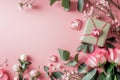 Valentine\'s day background. Pink roses, gift box and eucalyptus branches on pink background. Flat lay, top view Royalty Free Stock Photo