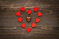 Valentine`s day background. Red hearts placed in heart shape on the wooden desk