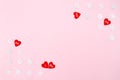 Valentine`s Day background. red hearts and snowflakes on pink background. Valentines day concept. Flat lay, top view, copy space Royalty Free Stock Photo