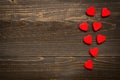 Valentine`s day background. Red hearts on the wooden desk