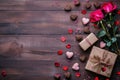Valentine\'s day background with rose, gift box and sweets on wooden table Royalty Free Stock Photo