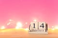 Valentine's day background. Vintage wooden calendar with 14th february date over table and pink bakground.