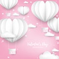 Valentine`s Day background of white heart shape hot air balloon with hanging box with LOVE text on pink sky with cloud. Royalty Free Stock Photo