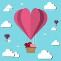 Valentine`s Day is a balloon paper heart floating on the sky with clouds in the sky.