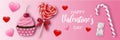 Valentine`s day banner with cupcake, lollipop, candy cane, gummy bear and heart shaped candies Royalty Free Stock Photo