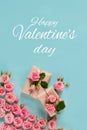 Valentine`s day banner.postcard favorite.Festive wreath of roses decoration with gifts and pink roses on a blue background. Royalty Free Stock Photo