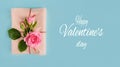 Valentine`s day banner.postcard favorite.Festive wreath of roses decoration with gifts and pink roses on a blue background. Royalty Free Stock Photo