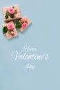 Valentines day banner.postcard favorite.Festive wreath of roses decoration with gifts and pink roses on a blue background. Royalty Free Stock Photo