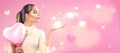 Valentine`s day. Beauty girl with pink heart shaped air balloon pointing hand Royalty Free Stock Photo